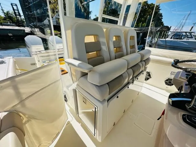 Slide: The Image of 2023 Boston Whaler 360 Outrage boat interior with cushioned seating. - 24