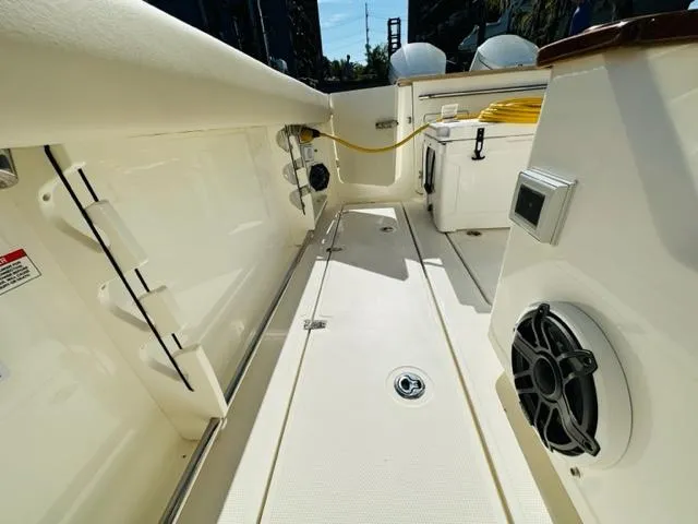Slide: The Image of 2023 Boston Whaler 360 Outrage boat deck with storage and speaker system. - 26