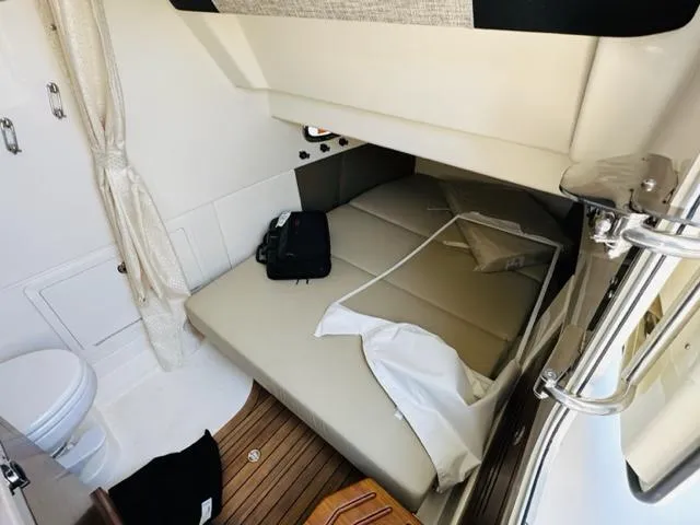 Slide: The Image of Interior cabin of 2023 Boston Whaler 360 Outrage with bed and toilet. - 28