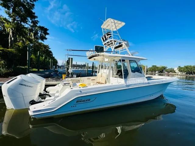 Slide: The Image of 2023 Boston Whaler 360 Outrage boat docked on a sunny day. - 3