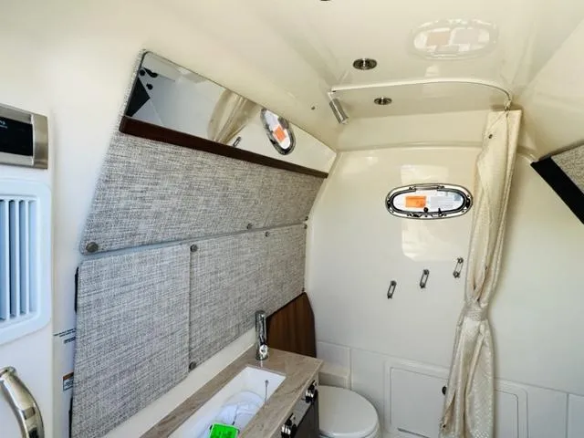 Slide: The Image of Interior cabin of 2023 Boston Whaler 360 Outrage with sink and toilet. - 30