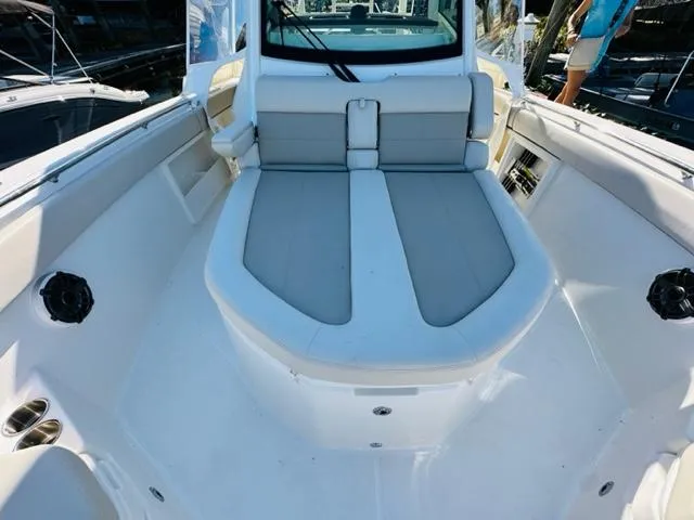 Slide: The Image of 2023 Boston Whaler 360 Outrage boat interior with cushioned seating. - 35