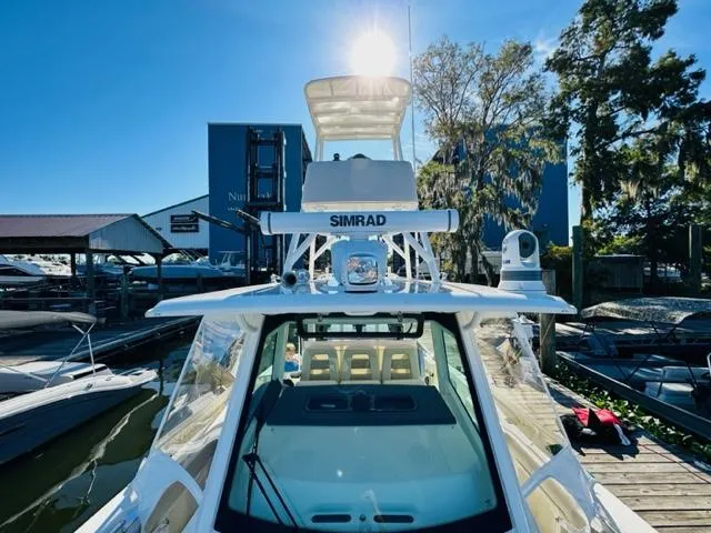 Slide: The Image of 2023 Boston Whaler 360 Outrage boat docked at marina under bright sun. - 36
