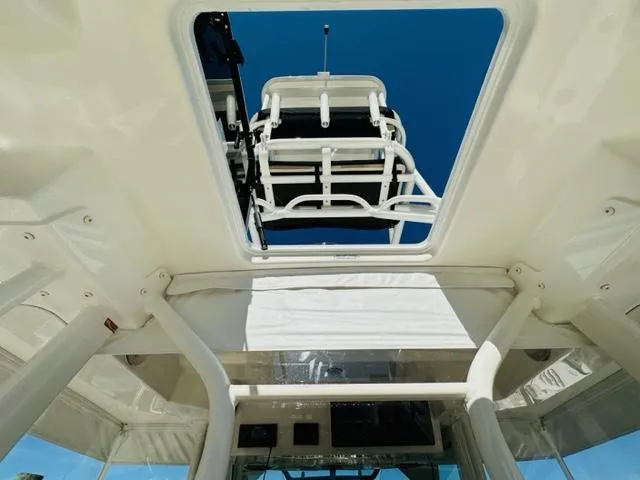 Slide: The Image of View from inside 2023 Boston Whaler 360 Outrage, looking up through the open roof hatch. - 41