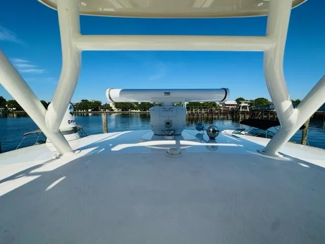 Slide: The Image of 2023 Boston Whaler 360 Outrage boat radar system with scenic waterfront view. - 42