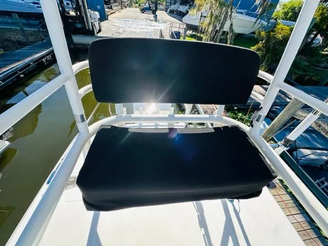 Slide: The Image of Boston Whaler 360 Outrage 2023 boat seat with black cushions in sunlight. - 48