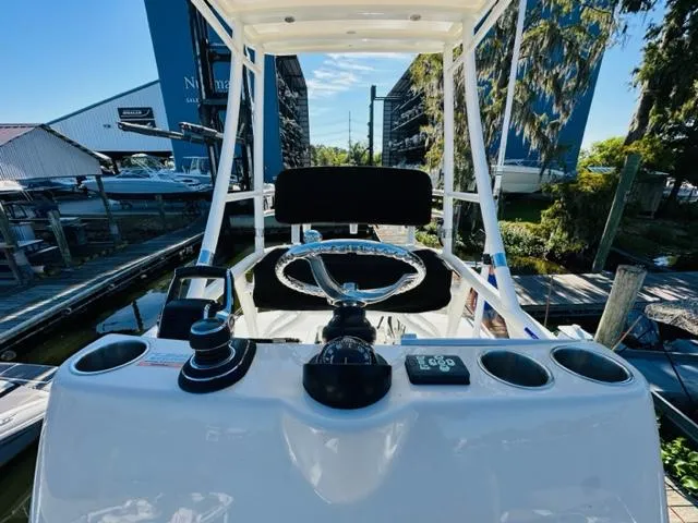 Slide: The Image of Boston Whaler 360 Outrage 2023 helm station with steering wheel and controls. - 49