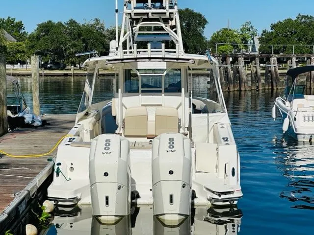 Slide: The Image of 2023 Boston Whaler 360 Outrage docked, rear view with twin 600 V12 engines. - 5