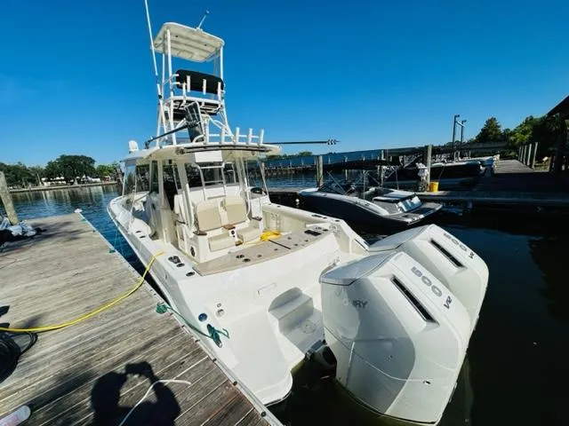 Slide: The Image of 2023 Boston Whaler 360 Outrage docked with twin Mercury engines. - 7
