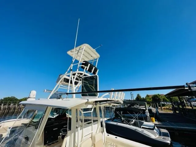 Slide: The Image of 2023 Boston Whaler 360 Outrage boat docked under clear blue sky. - 9