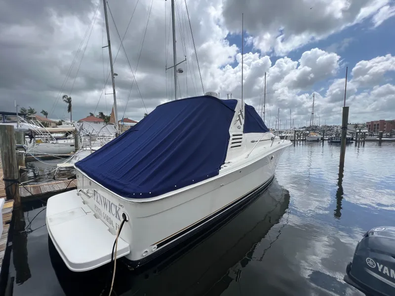 Slide: The Image of 2001 Sea Ray 340 Amberjack docked at marina with blue cover. - 0