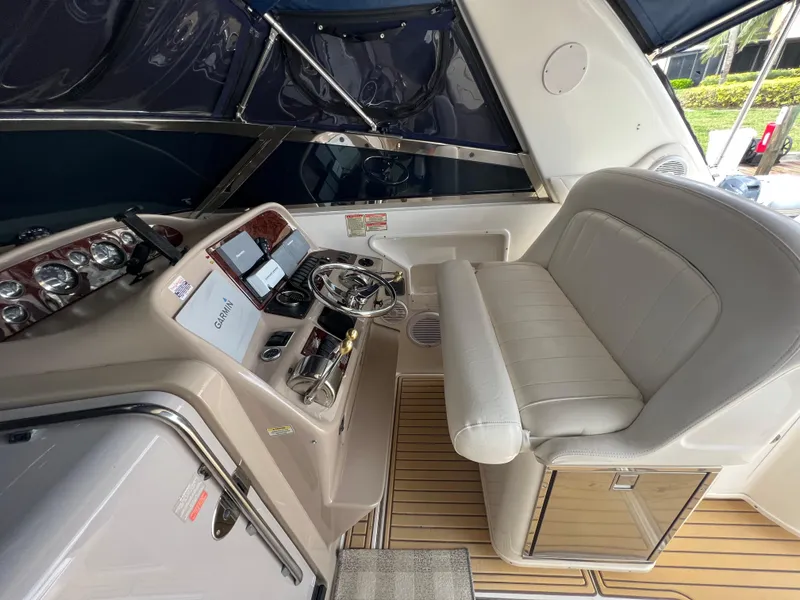 Slide: The Image of 2001 Sea Ray 340 Amberjack helm with Garmin navigation, leather seating, and wood accents. - 11