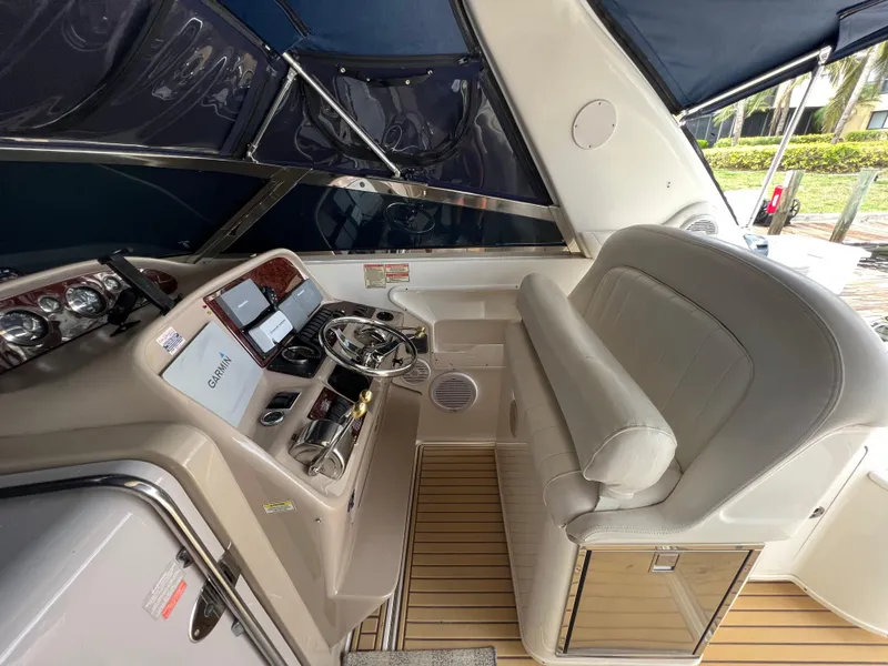 Slide: The Image of 2001 Sea Ray 340 Amberjack helm with Garmin navigation, leather seating, and wood accents. - 12