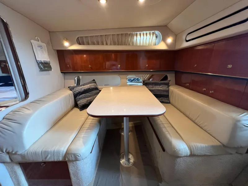 Slide: The Image of 2001 Sea Ray 340 Amberjack cabin interior with dining area and leather seating. - 20