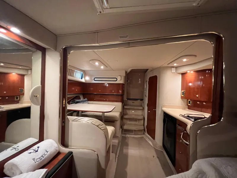 Slide: The Image of Interior of 2001 Sea Ray 340 Amberjack yacht with kitchen and dining area. - 23