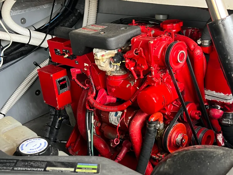 Slide: The Image of Engine compartment of a 2001 Sea Ray 340 Amberjack boat with red engine components. - 28