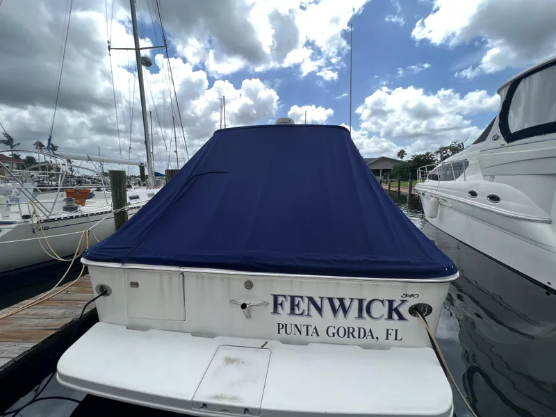 Slide: The Image of 2001 Sea Ray 340 Amberjack docked in Punta Gorda, FL with blue cover. - 4