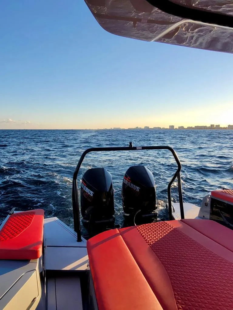 Slide: The Image of 2022 BRABUS Shadow 900 ST boat with twin engines on open water at sunset. - 4