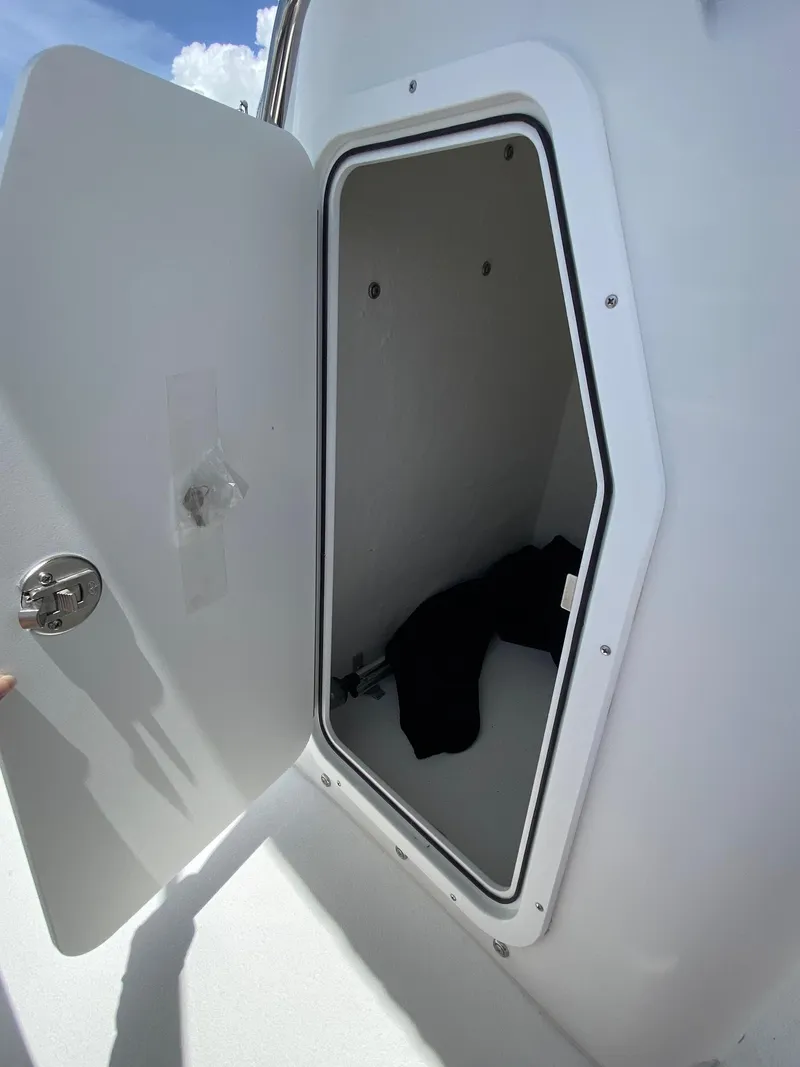 Slide: The Image of Open storage compartment on a 2024 Savannah SS19 boat. - 16