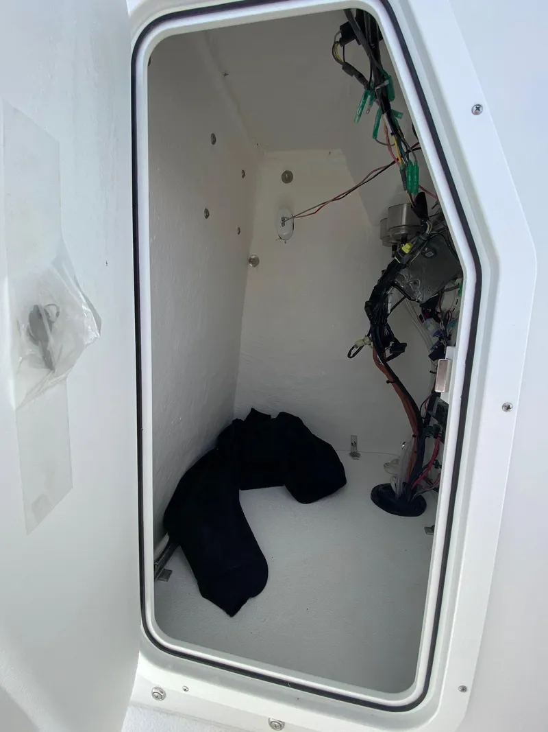 Slide: The Image of Interior compartment of 2024 Savannah SS19 boat with wiring and storage space. - 17