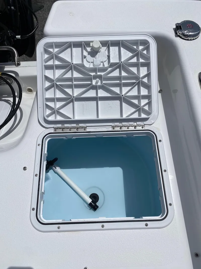 Slide: The Image of Open storage compartment on a 2024 Savannah SS19 boat. - 19