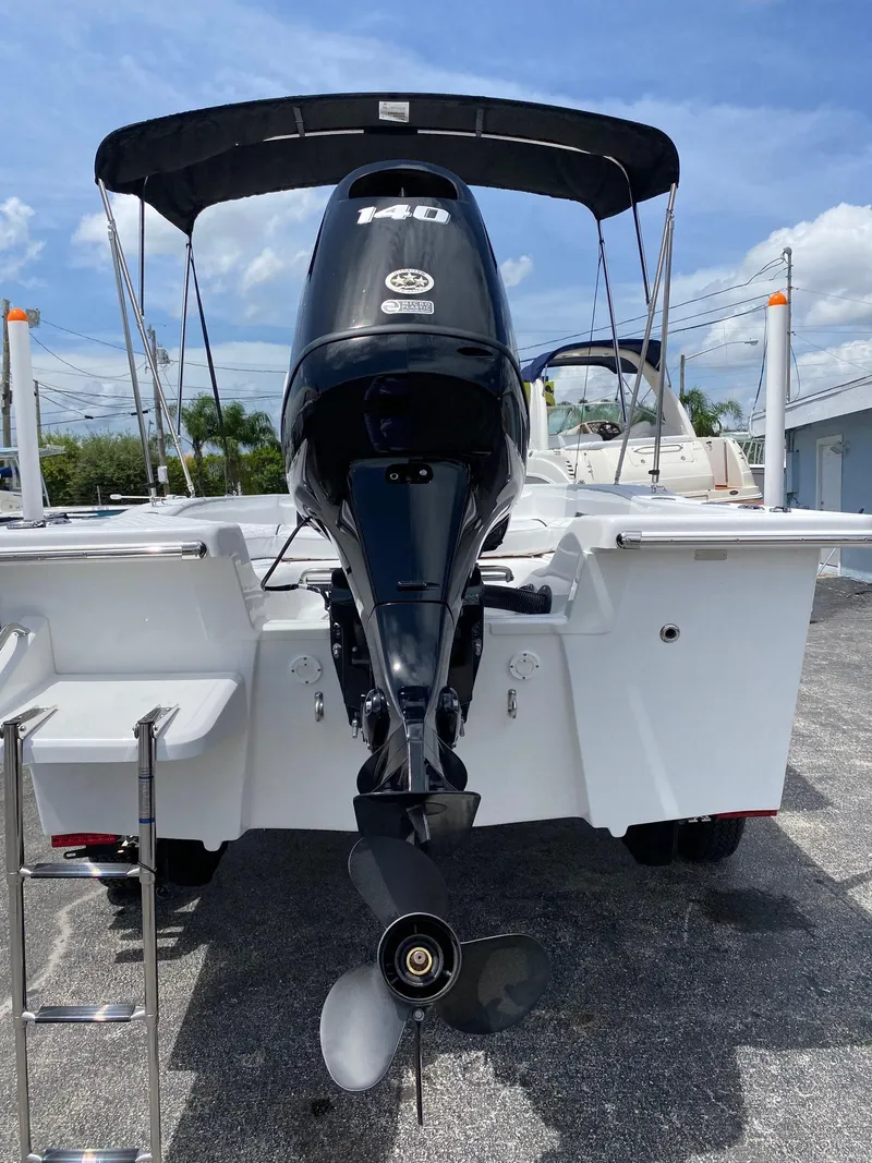 Slide: The Image of 2024 Savannah SS19 boat with outboard motor and bimini top. - 23