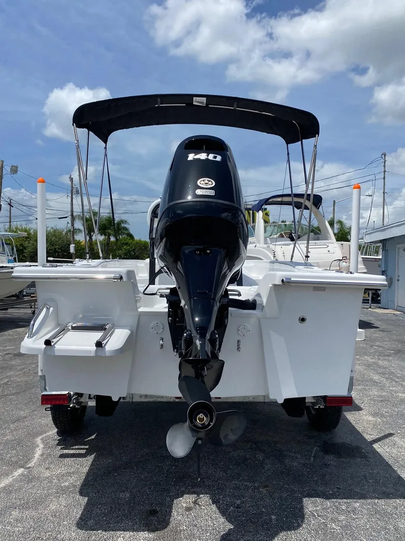Slide: The Image of 2024 Savannah SS19 boat with 140 HP outboard motor, rear view. - 3