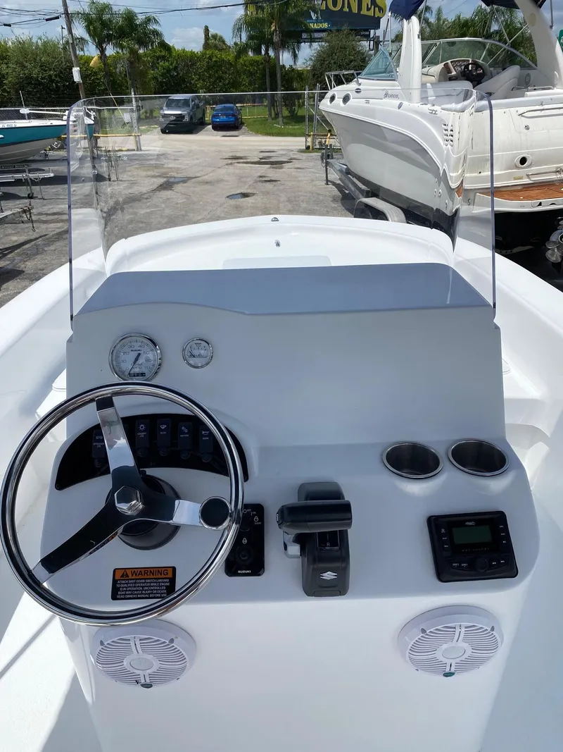 Slide: The Image of 2024 Savannah SS19 boat console with steering wheel, gauges, and controls. - 5