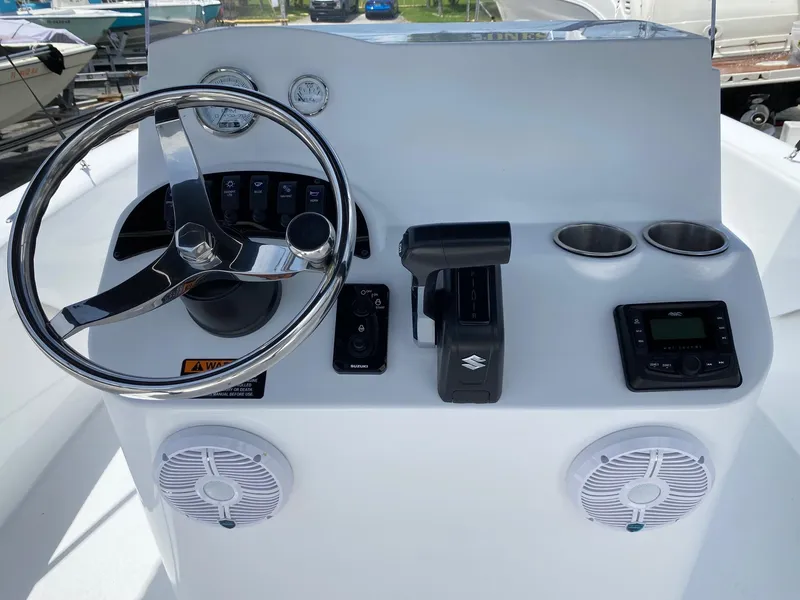 Slide: The Image of 2024 Savannah SS19 boat dashboard with steering wheel, controls, gauges, and cup holders. - 9