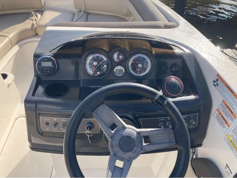 Slide: The Image of 2017 Bayliner 190 boat dashboard with steering wheel, gauges, and controls. - 2