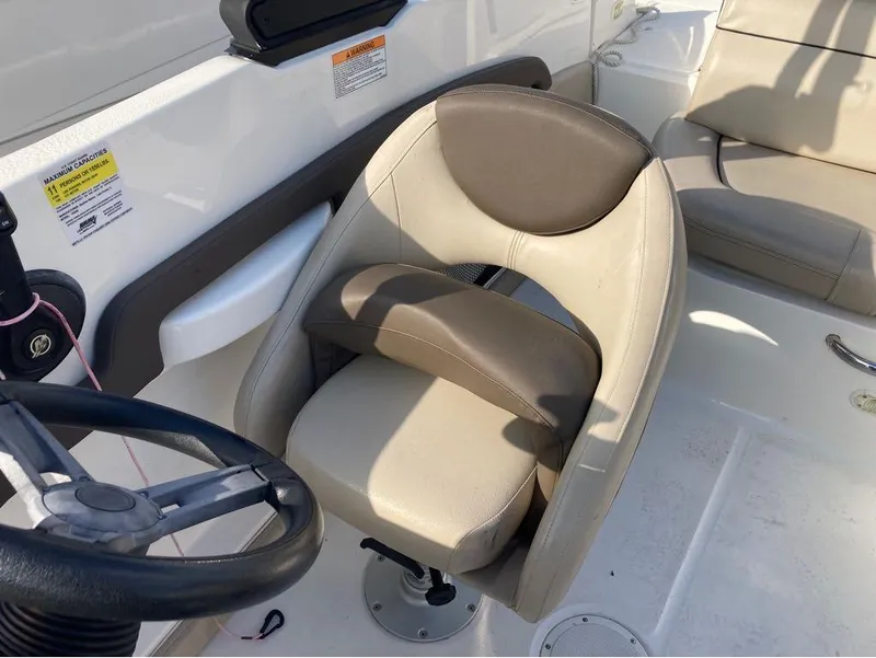Slide: The Image of Captain's seat and steering wheel of a 2017 Bayliner 190 boat. - 4