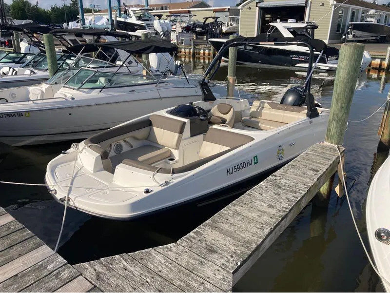 Slide: The Image of 2017 Bayliner 190 boat docked at a marina with other boats. - 6