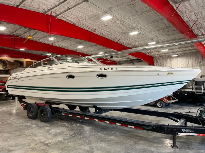 Slide: The Image of 1999 Formula 330 SS Sun Sport boat on trailer in indoor storage facility. - 1