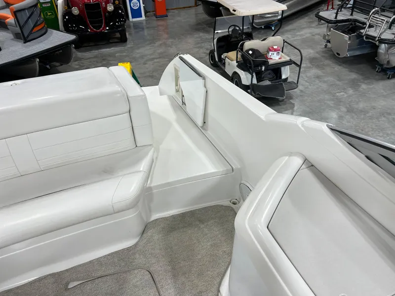 Slide: The Image of 1999 Formula 330 SS Sun Sport boat interior with white seating and storage compartments. - 6