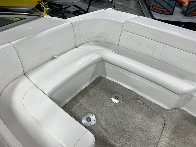 Slide: The Image of 1999 Formula 330 SS Sun Sport boat interior with white leather seating and carpeted floor. - 7