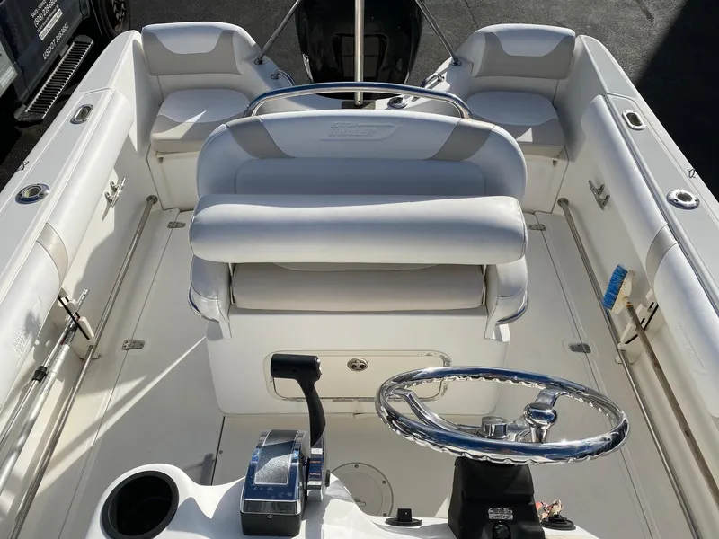 Slide: The Image of 2004 Boston Whaler 210 Outrage boat interior with steering wheel and seating. - 10