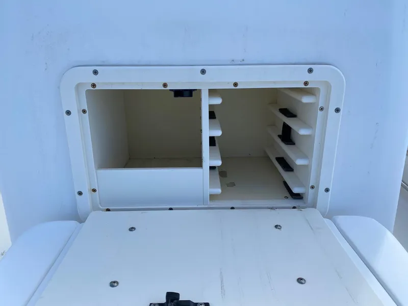 Slide: The Image of Storage compartment of a 2004 Boston Whaler 210 Outrage boat. - 12