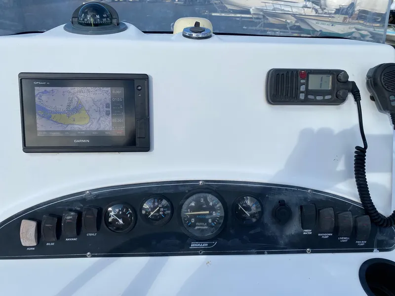 Slide: The Image of Dashboard of a 2004 Boston Whaler 210 Outrage with Garmin GPS and marine radio. - 13