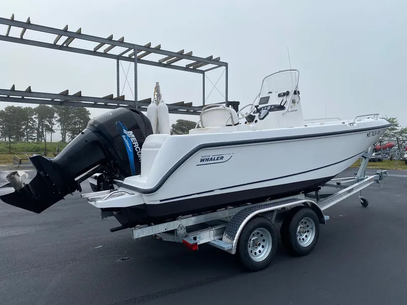 Slide: The Image of 2004 Boston Whaler 210 Outrage on trailer with Mercury outboard motor. - 4