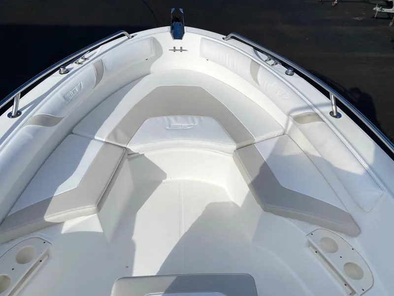 Slide: The Image of 2004 Boston Whaler 210 Outrage boat bow seating area with white cushions. - 6