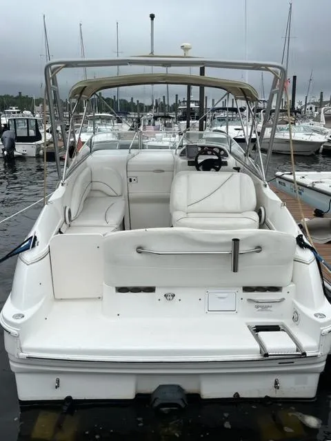Slide: The Image of 2002 Larson 254 Cabrio boat docked at a marina. - 2