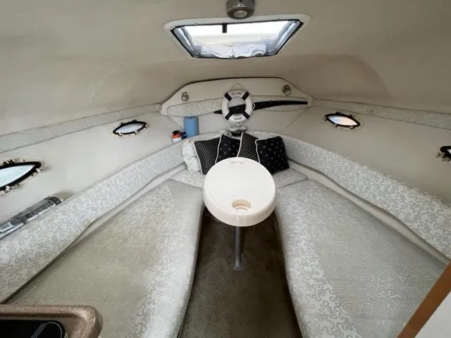 Slide: The Image of Interior cabin of a 2002 Larson 254 Cabrio boat with seating and table. - 9