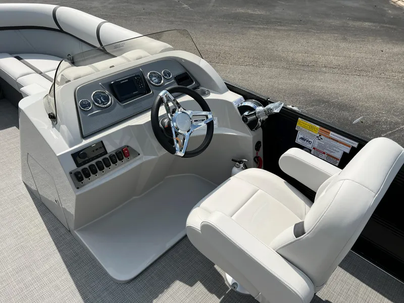 Slide: The Image of 2024 Crest Classic LX 220 boat helm with modern controls and comfortable seating. - 12
