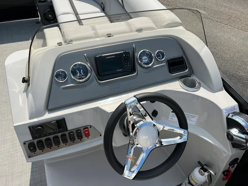 Slide: The Image of 2024 Crest Classic LX 220 boat dashboard with steering wheel and control panel. - 13