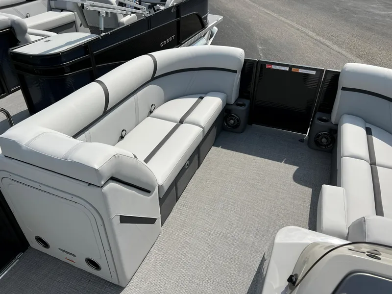 Slide: The Image of 2024 Crest Classic LX 220 pontoon boat interior with plush seating. - 14