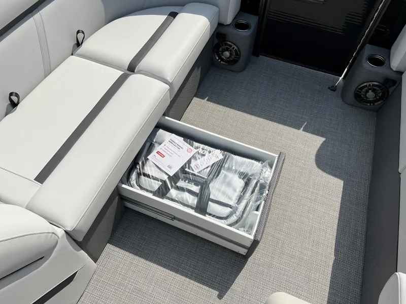 Slide: The Image of 2024 Crest Classic LX 220 boat interior with storage compartment open. - 15