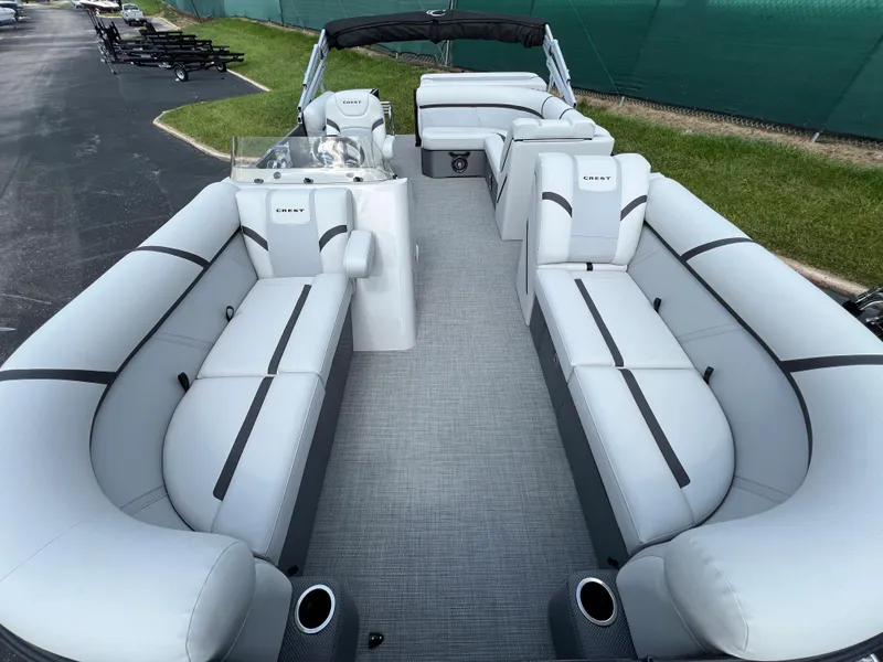Slide: The Image of 2024 Crest Classic LX 220 pontoon boat with spacious seating and modern design. - 4
