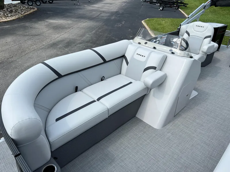Slide: The Image of 2024 Crest Classic LX 220 boat interior with plush seating and modern design. - 5