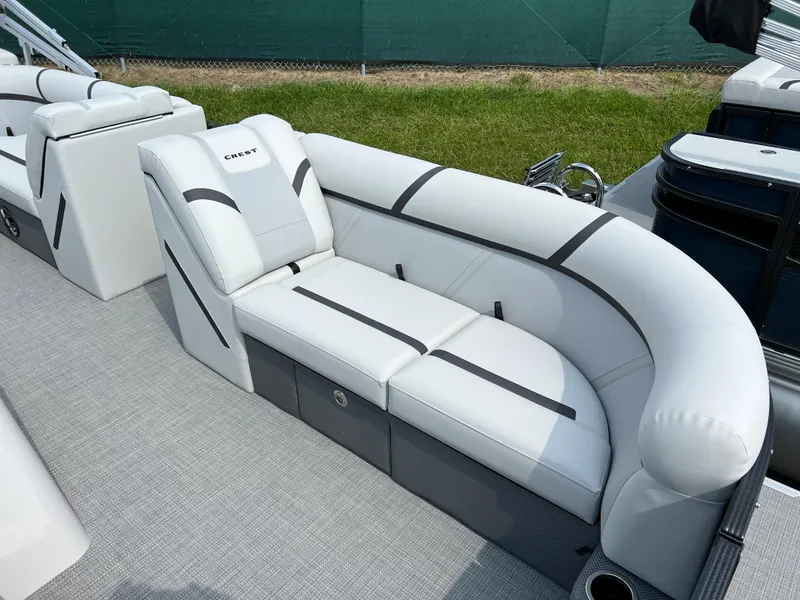 Slide: The Image of 2024 Crest Classic LX 220 boat with luxurious white seating. - 6