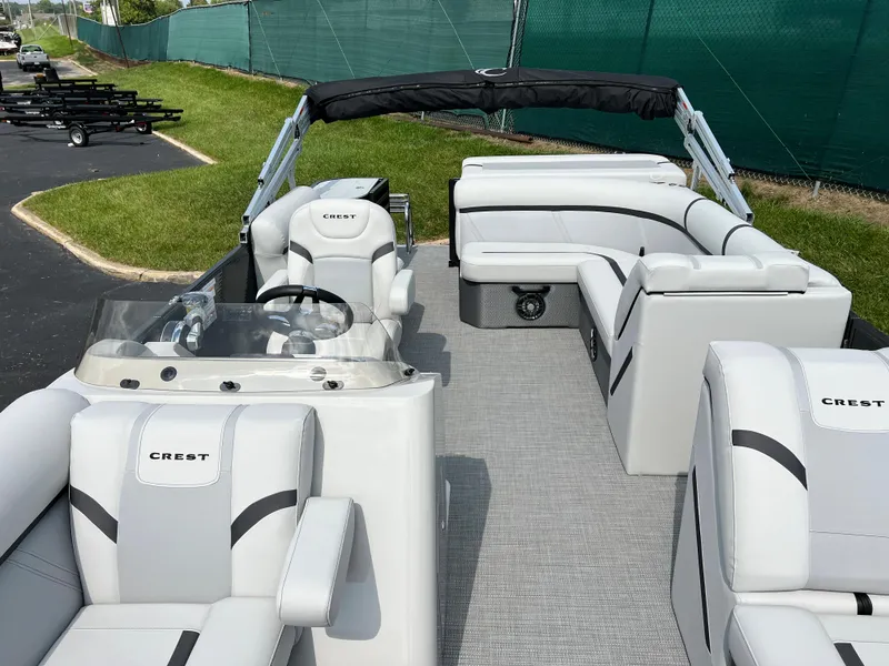 Slide: The Image of 2024 Crest Classic LX 220 pontoon boat with spacious seating and modern design. - 7